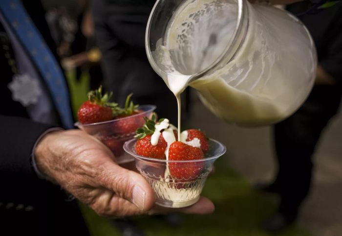 pouring cream on berries
