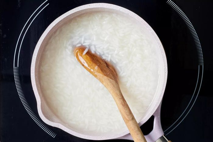 Stirring a pot of jasmine rice on the stovetop