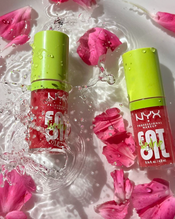 The lip oils floating in water with rose petals