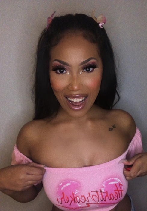 Me, smiling, wearing NYX Butter Gloss