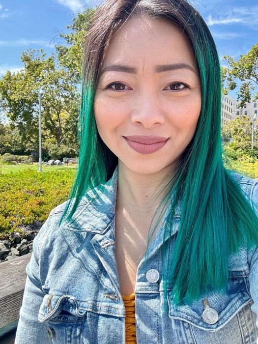 reviewer's teal-colored hair after applying the dye