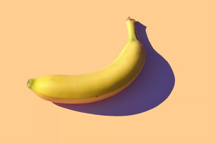 banana set against a vibrant orange backdrop
