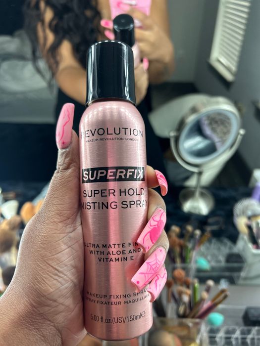 me holding setting spray