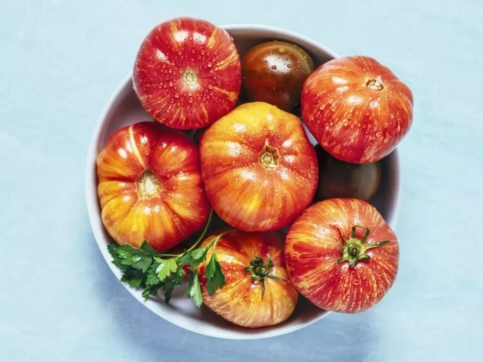 Heirloom Tomatoes in a Bowl on a Blue Background
