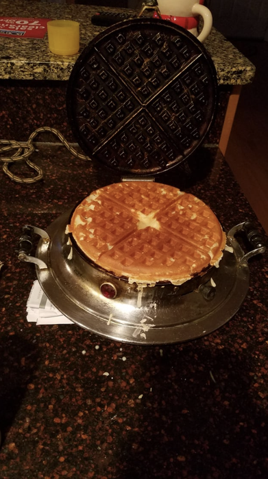 A waffle iron cooking waffles.