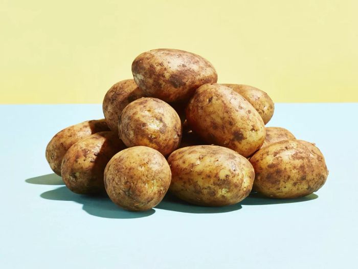 A collection of potatoes resting on a countertop