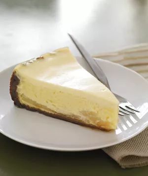 A slice of gingersnap-pear cheesecake elegantly presented on a white plate
