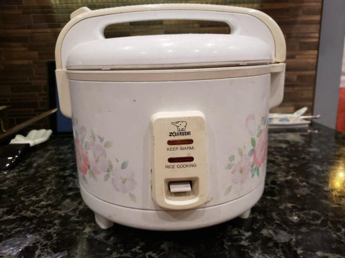 A rice maker featuring a beautiful floral design.