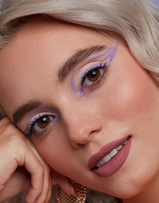 A model sporting a striking lavender eyeliner