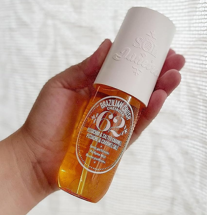 Image of a reviewer holding the fragrance mist bottle
