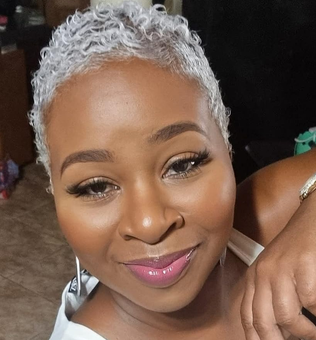 An image of a Black reviewer rocking the strawberry cheesecake lip gloss