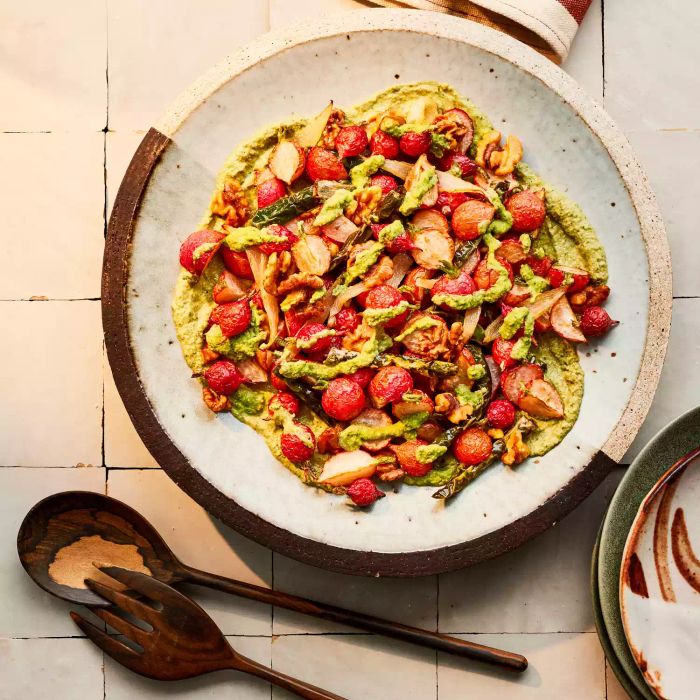 Radish Chicharrones Served on a Bed of Salsa Verde in a Large Plate with Wooden Serving Utensils on the Side