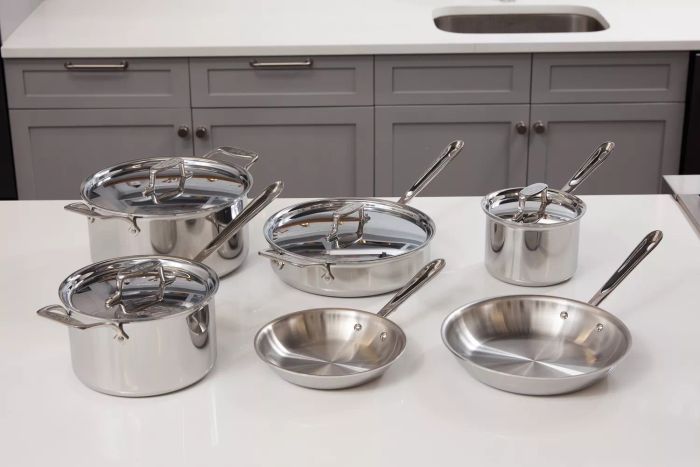 The All-Clad D5 Stainless Brushed 5-Ply Bonded 10-Piece Cookware Set displayed on a pristine white kitchen countertop.