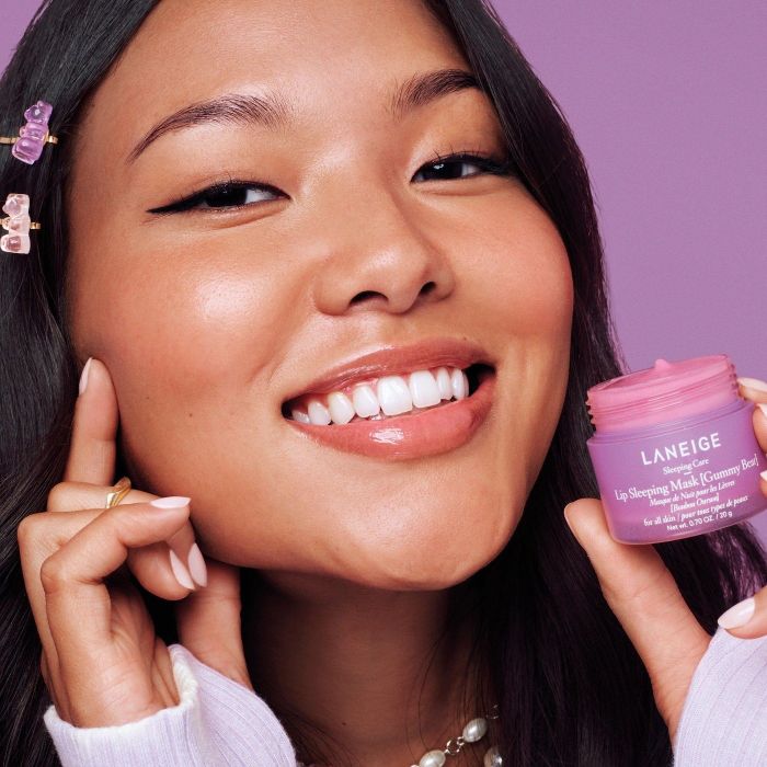 A model holding the gummy bear-scented lip mask.