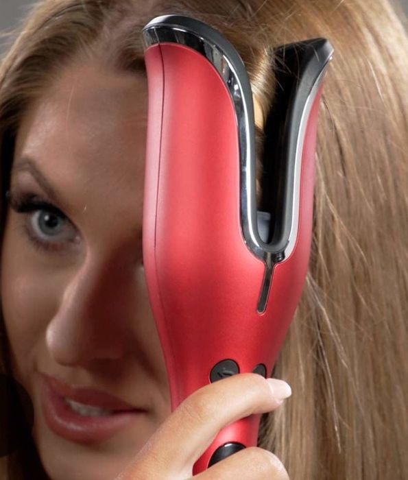 A model styling her hair using a curling iron.