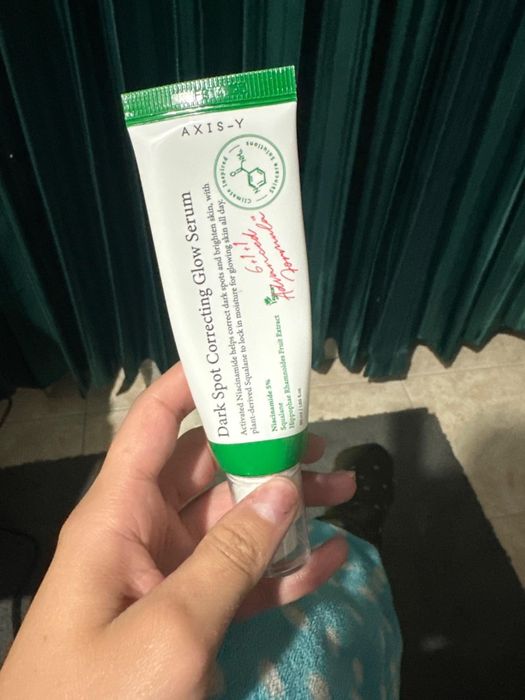 A person holding a tube of the AXIS-Y serum.