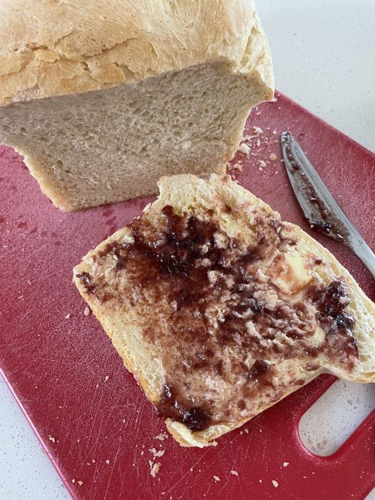 A slice of bread topped with butter and jam.