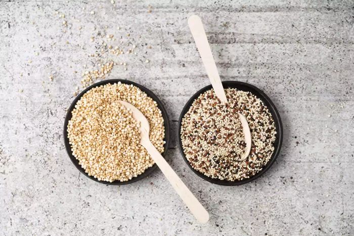 Two bowls filled with raw quinoa placed side by side