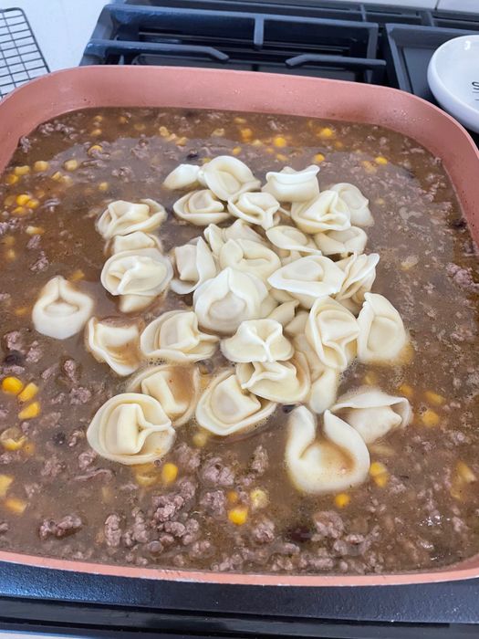 Tortellini cooking with beef.