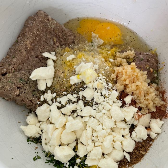 Before heading to the birthday party, I mixed the meatball ingredients in a bowl, and while I was away, my husband rolled them into balls and arranged them on the sheet pan.