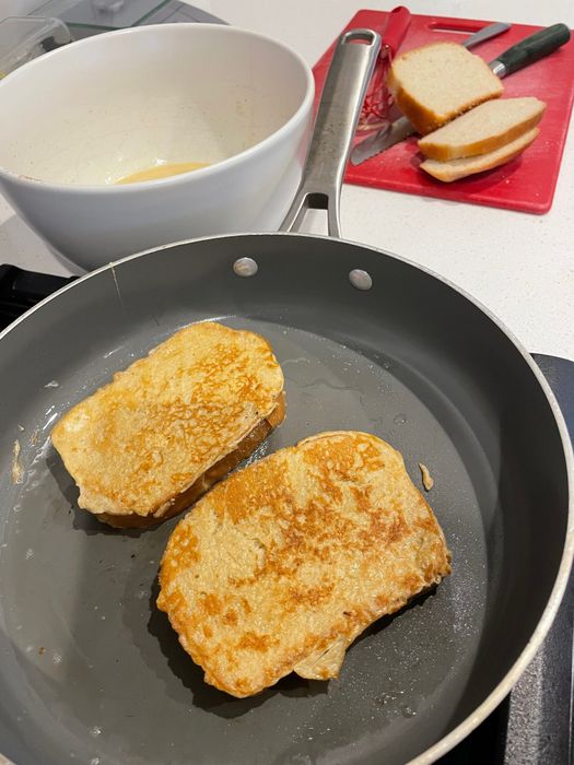 French toast cooking in a pan.