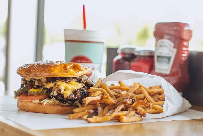 Tucker's casually features Creekstone Farms beef, topped with a generous heap of grilled onions.