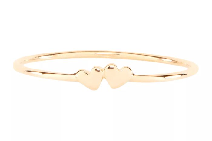 The Catbird Twin Hearts Gold Stacking Ring is a delicate and charming addition to any jewelry collection.