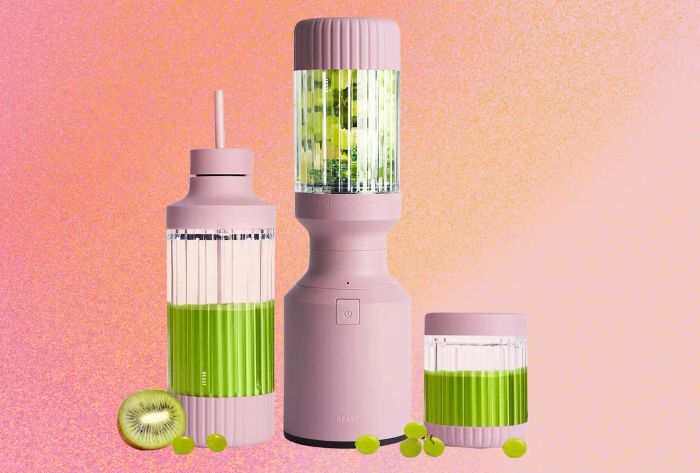 The Beast Personal Blender featuring kiwis and grapes against a pink gradient backdrop