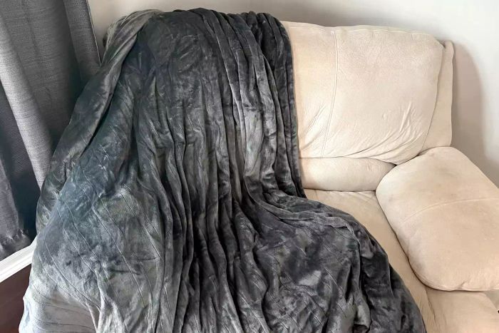 The Westinghouse Flannel Electric Blanket elegantly draped over a chair