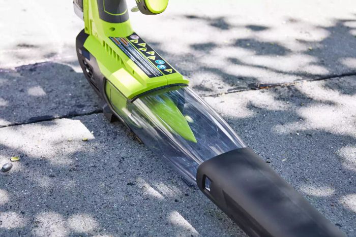 Ryobi ONE+ 18V 100 MPH 280 CFM Cordless Battery Variable-Speed Jet Fan Leaf Blower resting on a cement sidewalk.