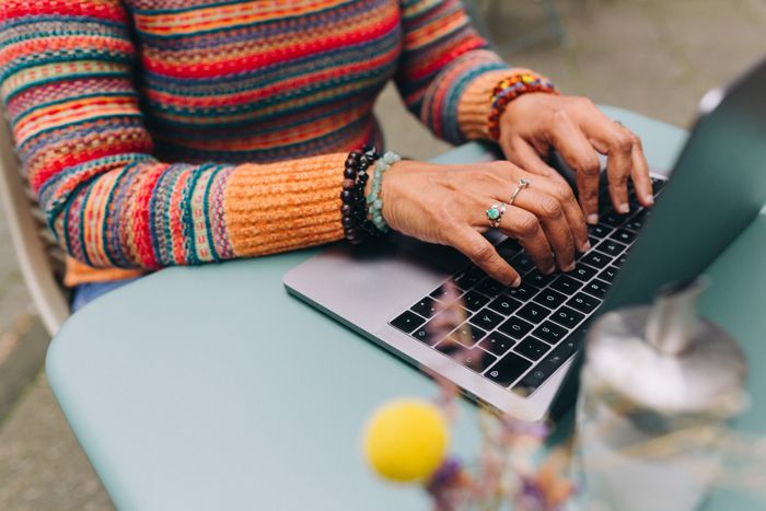 hands on a laptop