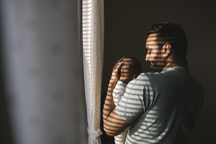 a man cradling a baby