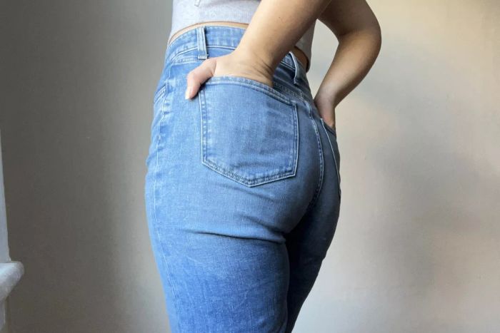 A person with their hands resting in the back pockets of Joe's Jeans The Mia High-Rise Wide Leg Jean.