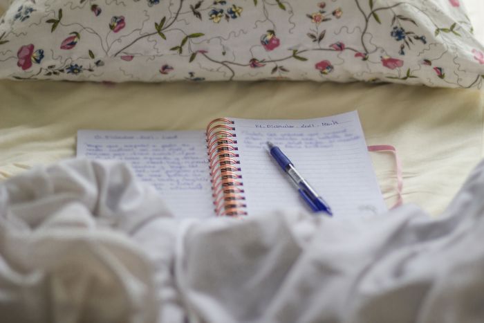 an open journal resting on a bed
