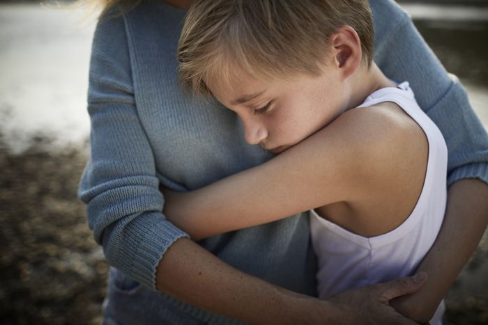 a child embracing a woman