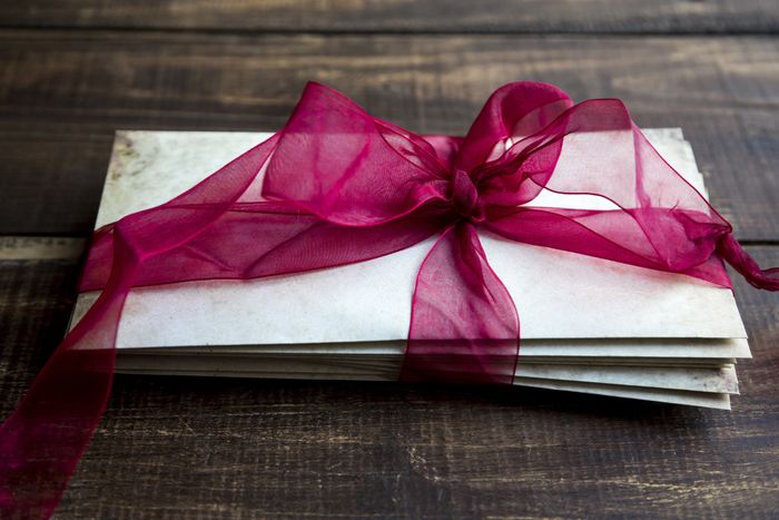 Envelopes secured with a delicate bow