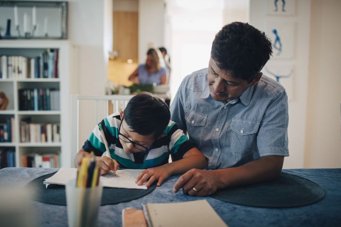 a man helping a child with homework