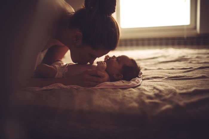 A woman sharing a kiss with a baby