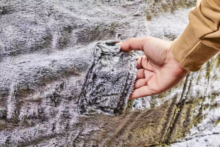 Close-up of a hand gripping the handle of a Lovesac Customizable Sac