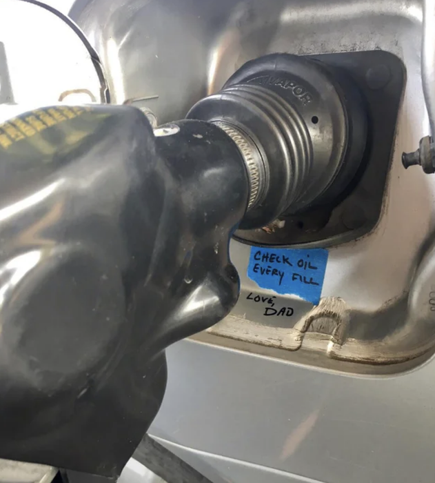 a note stuck on the gas tank with tape