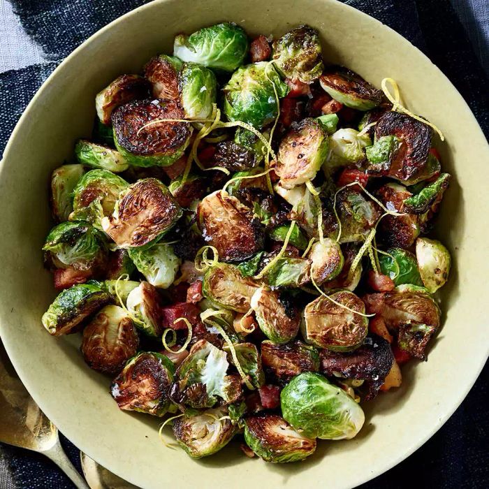 Crispy Brussels sprouts with pancetta and lemon served in a bowl.
