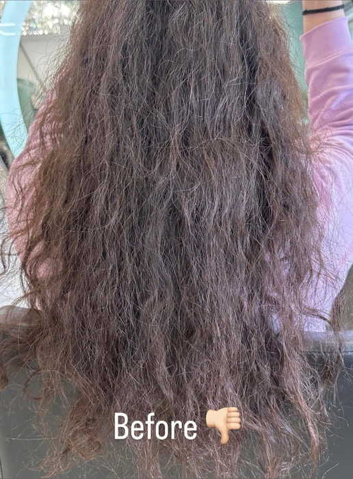 A reviewer facing away, displaying long, untreated hair