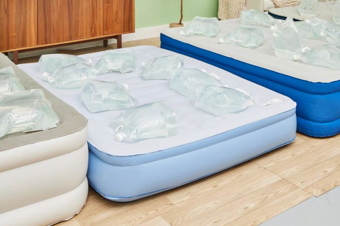 Water-filled bags rest on the Simmons Lumbar Firm Full Tri-Zone Air Mattress.