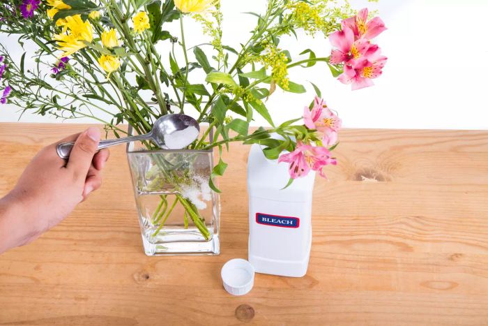 adding bleach to vase with flowers