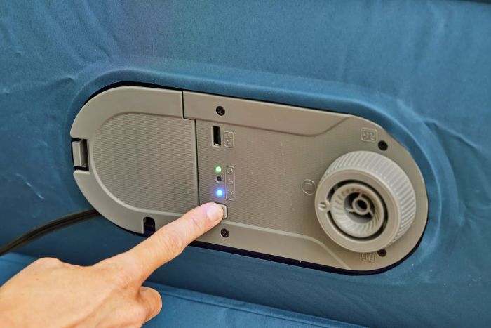 A person pushes a button on the Sealy AlwayzAire Flocked Top Air Mattress