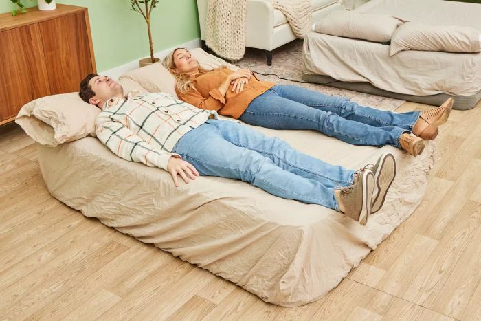 A person rests on the SereneLife Luxury Full Size Air Mattress with Built-in High-Speed Pump