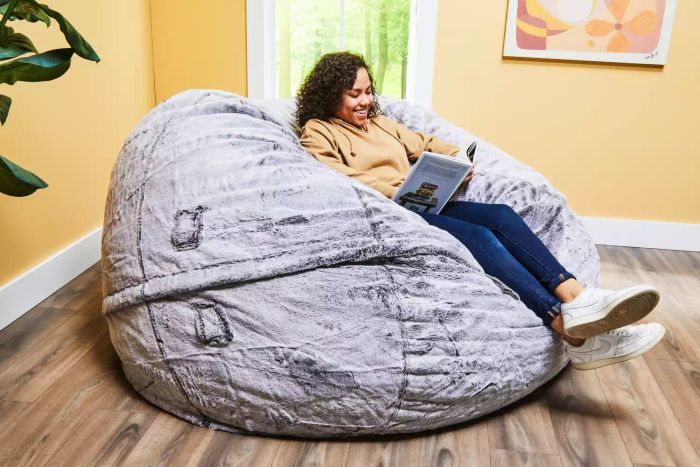 Person reading while seated in a Lovesac Customizable Sac