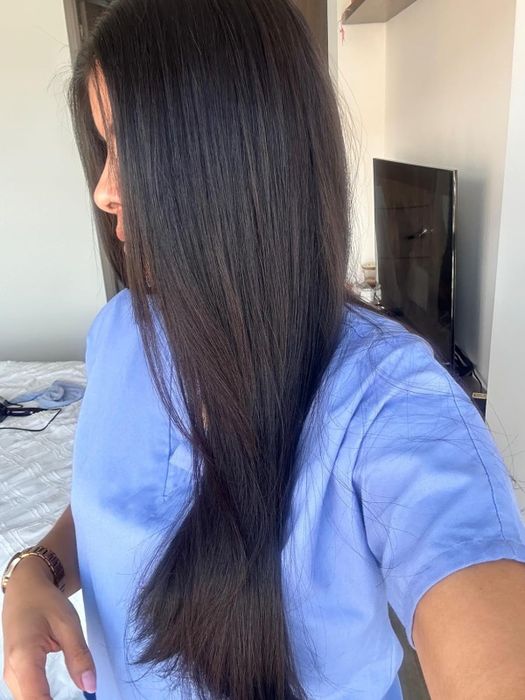 A woman demonstrating long, straight hair, ideal for articles related to hair care products