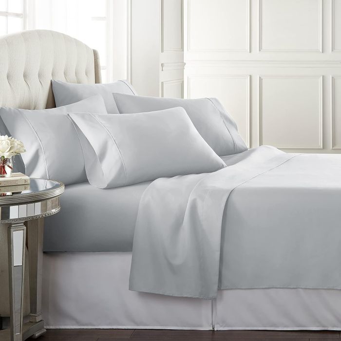 The white sheets laid out neatly on a bed.