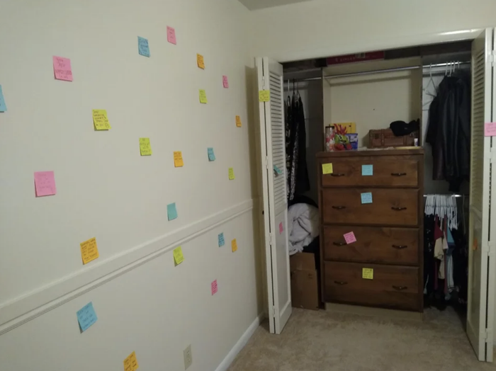sticky notes adorning the walls of a bedroom
